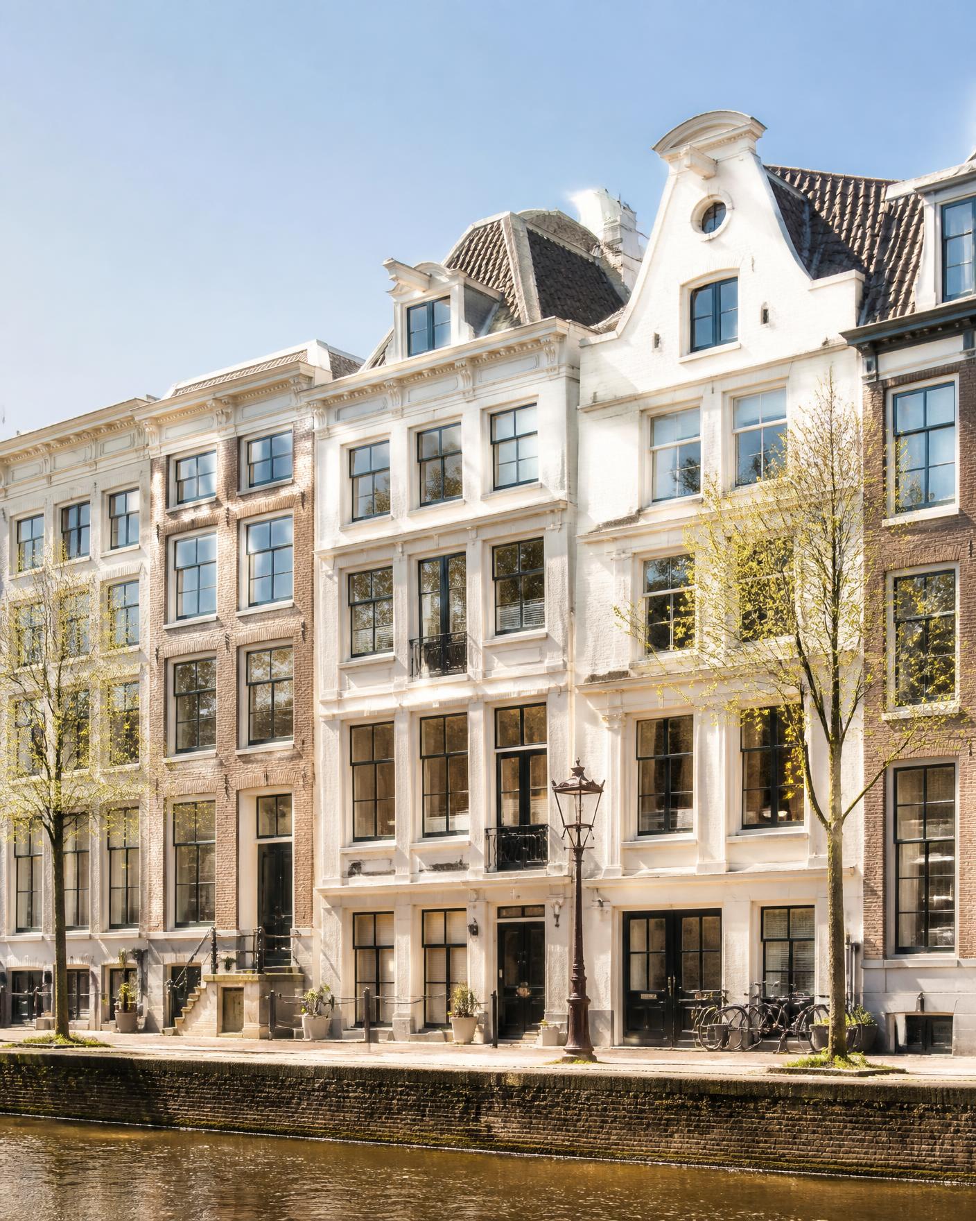 Row of Amsterdam canal-side apartment buildings in bright daylight